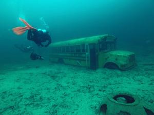 Divers with school bus in Gray Quarry. Photo by Carter Warden