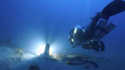 Diver with ancient ram discovery, Sicily, Italy. Photo by Mario Arena